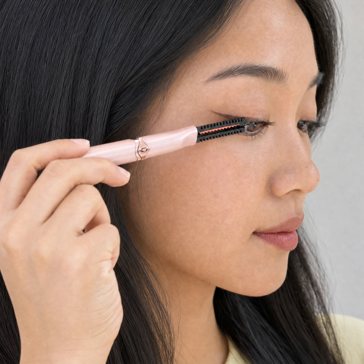 Lumivea heated lash curler positioned along the upper lashes